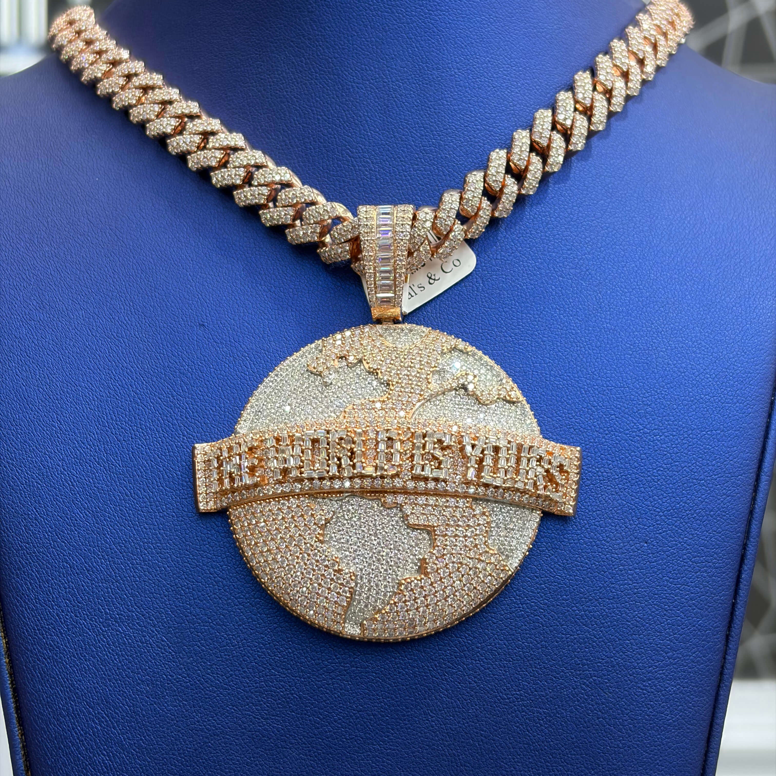 Gold necklace with a large pendant on a blue mannequin